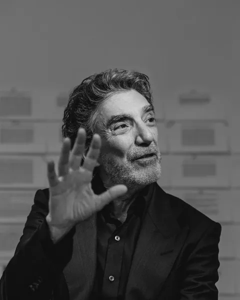Chuck Lorre gesturing mid-conversation, photographed for Playboy at Milwood Studios